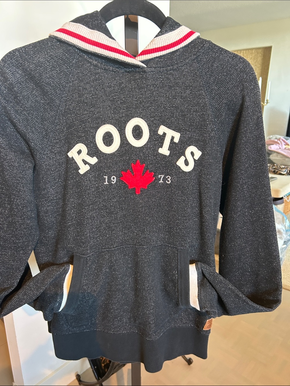Roots women’s black Zip-Up Hoodie with Red Maple Logo. Knit cuffs and hoodie.